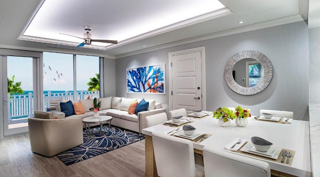 An artist 's impression of a living room and dining room.