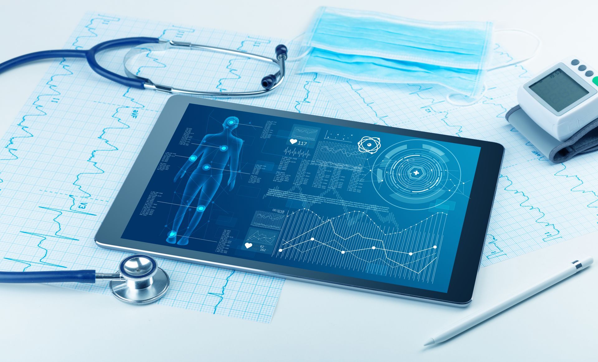 A tablet displaying digital health data, stethoscope, blood pressure monitor, and face mask on a medical chart background.