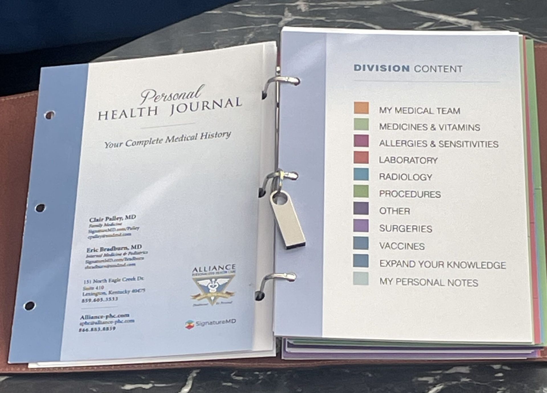 Open binder with a health journal on the left and a colorful habit list on the right.