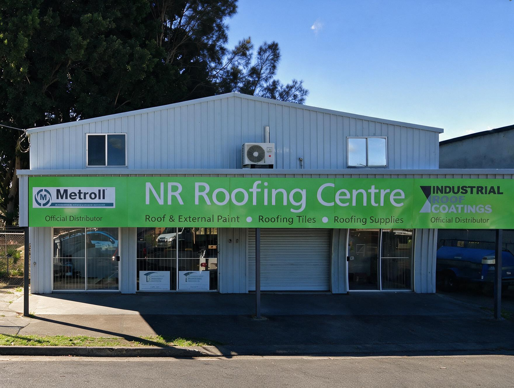 NR Roofing Centre storefront with green signage on a sunny day