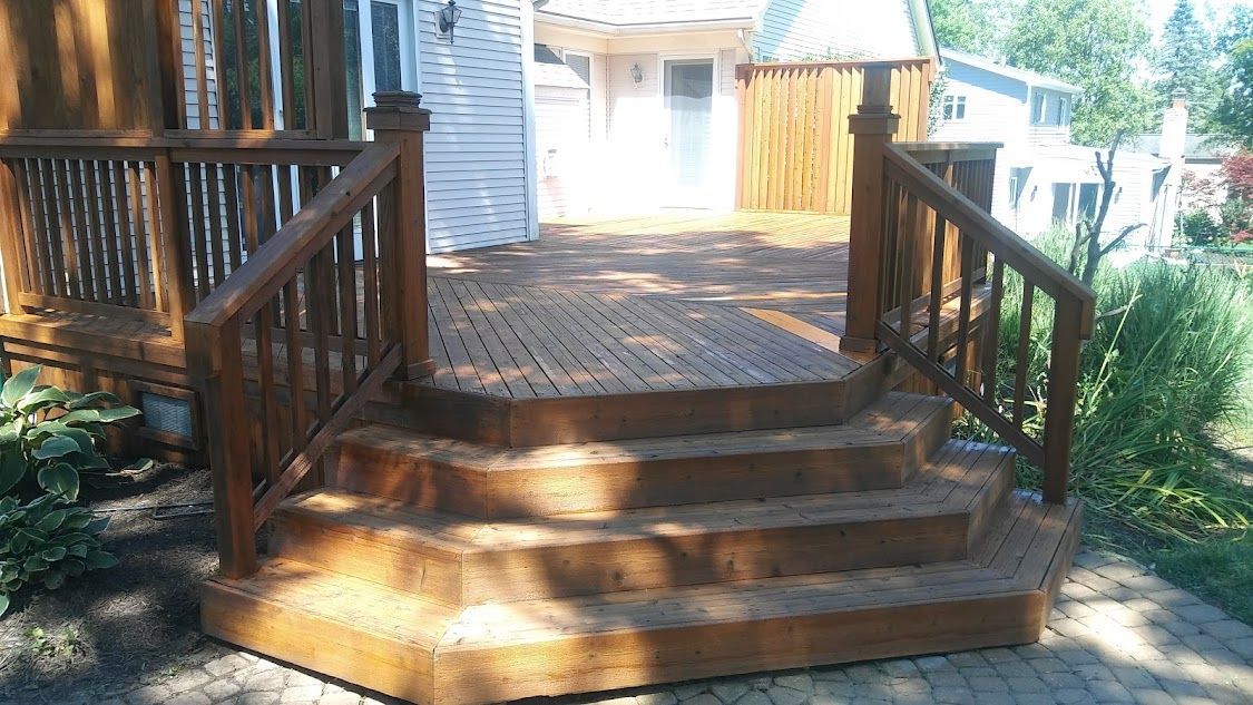 A wooden deck with stairs leading up to it.