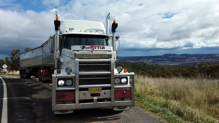 White Semi-Truck Hauling a Trailer on A Rural Road — Rainbow and Sons Heavy Haulage in Wells Crossing, NSW