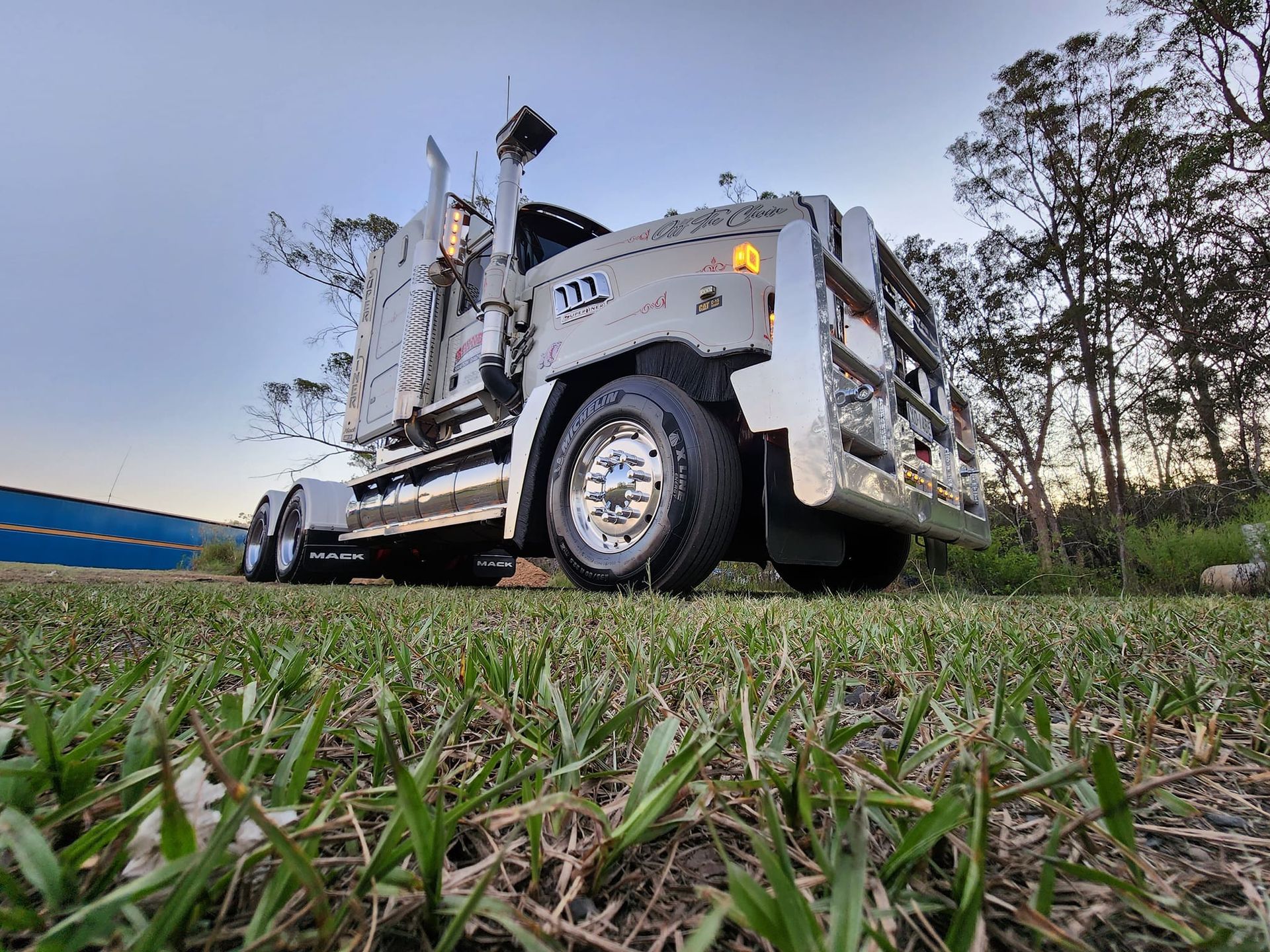 Low-Angle View of A White Off-Road Vehicle on Grass at Dusk — Rainbow and Sons Heavy Haulage in Wells Crossing, NSW