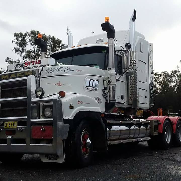 White Semi Truck with Chrome Grille Parked on A Wet Road — Rainbow and Sons Heavy Haulage in Wells Crossing, NSW