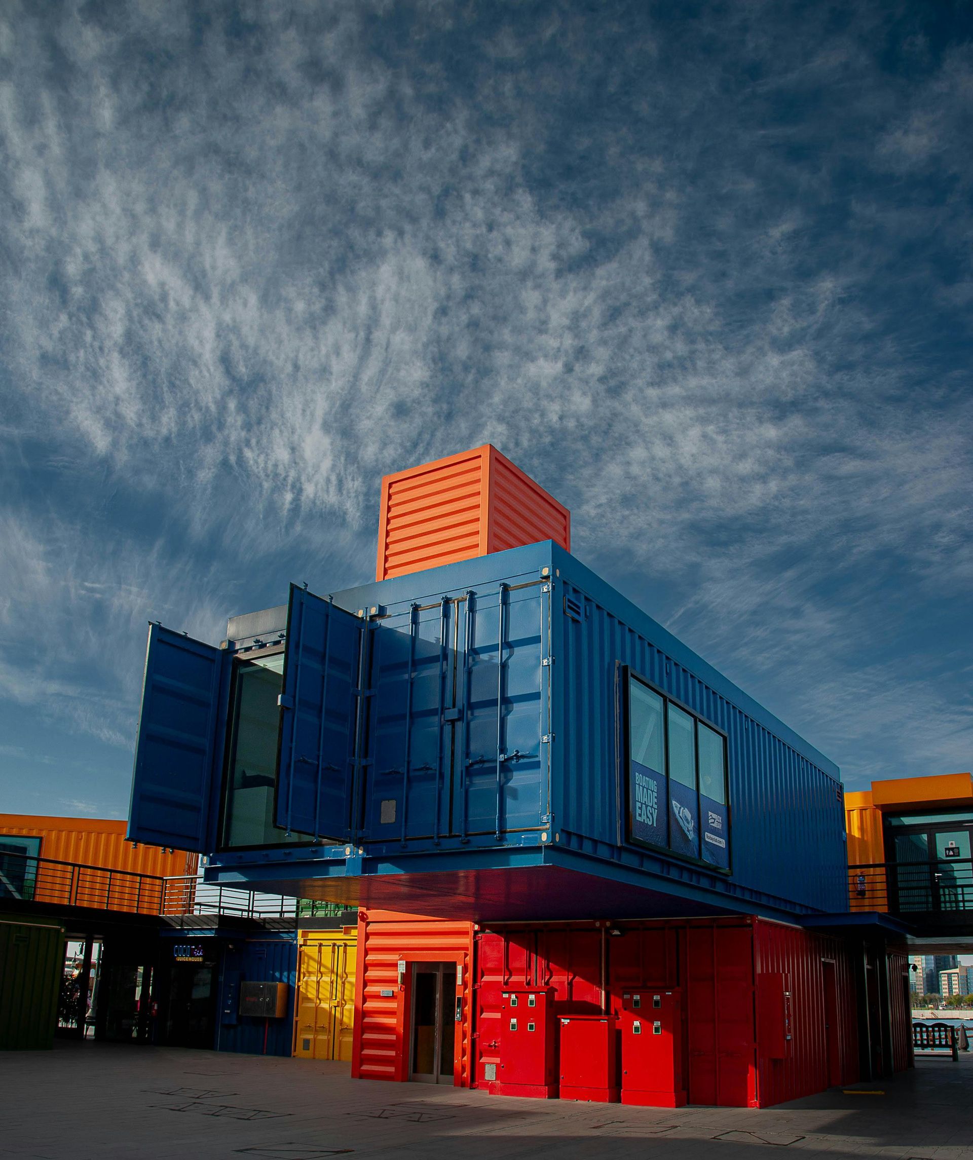 Colourful Stacked Shipping Containers Forming a Modern Building — Rainbow and Sons Heavy Haulage in Coffs Harbour, NSW