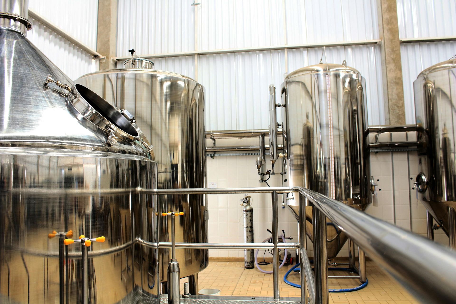 Shiny Stainless Steel Brewing Tanks and Pipes — Rainbow and Sons Heavy Haulage in Wells Crossing, NSW