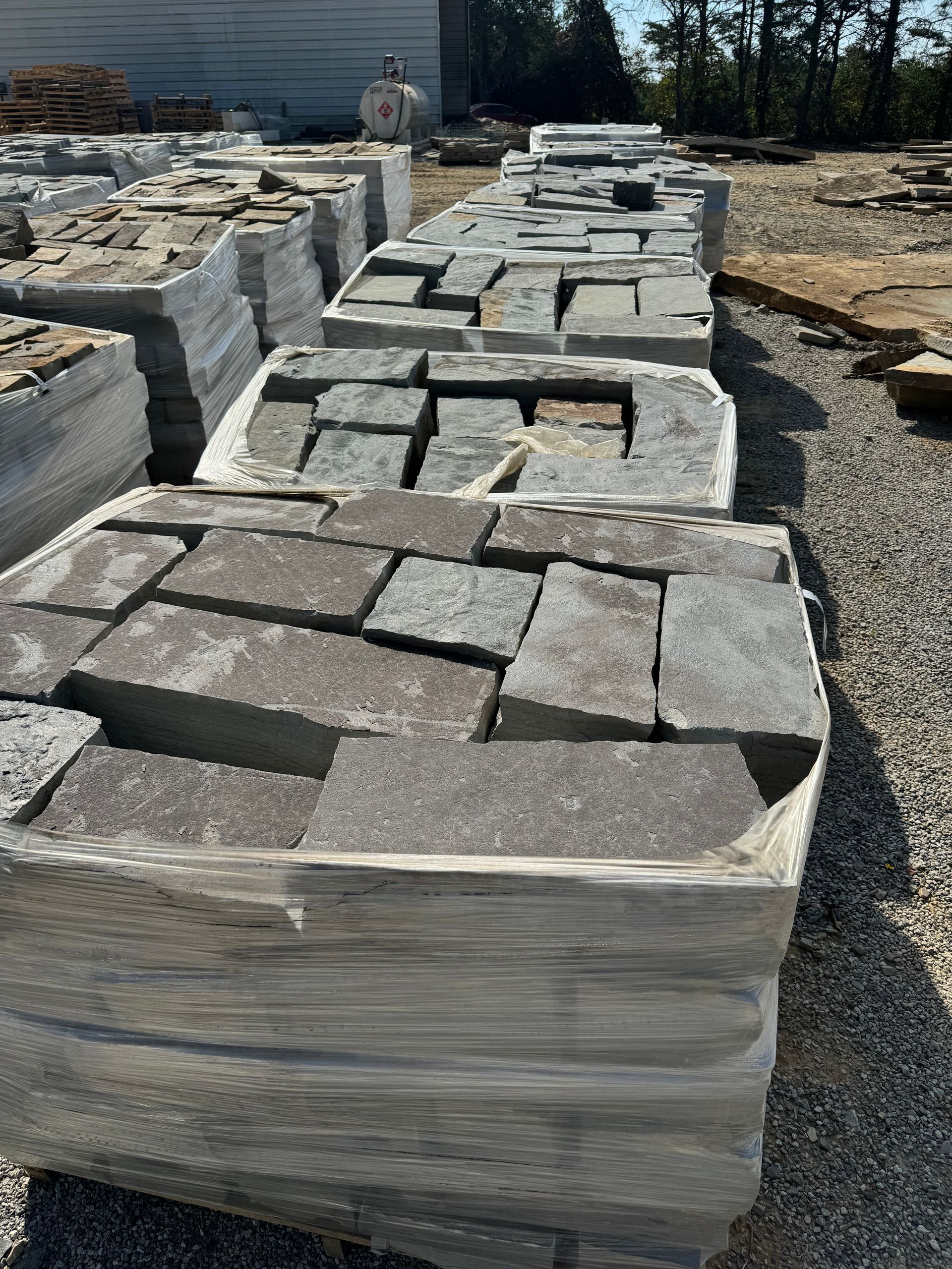 A bunch of bricks are stacked on top of each other in a pile.