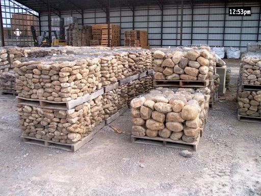 Pallets of rocks are stacked on top of each other in a warehouse.