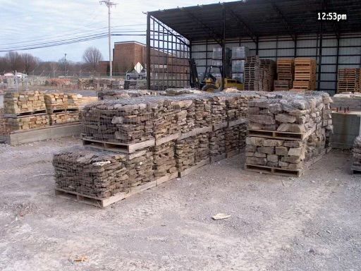 A warehouse filled with pallets of rocks and bricks