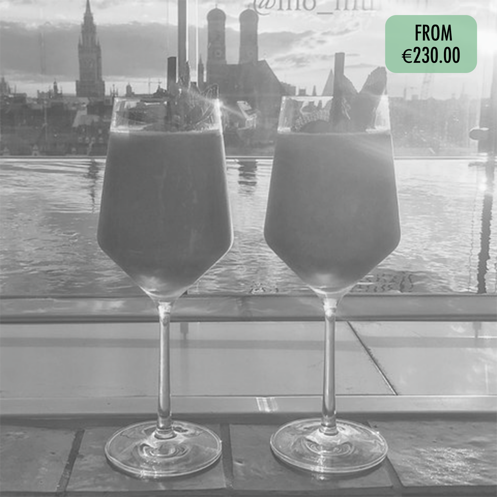 A black and white photo of two wine glasses with drinks in them