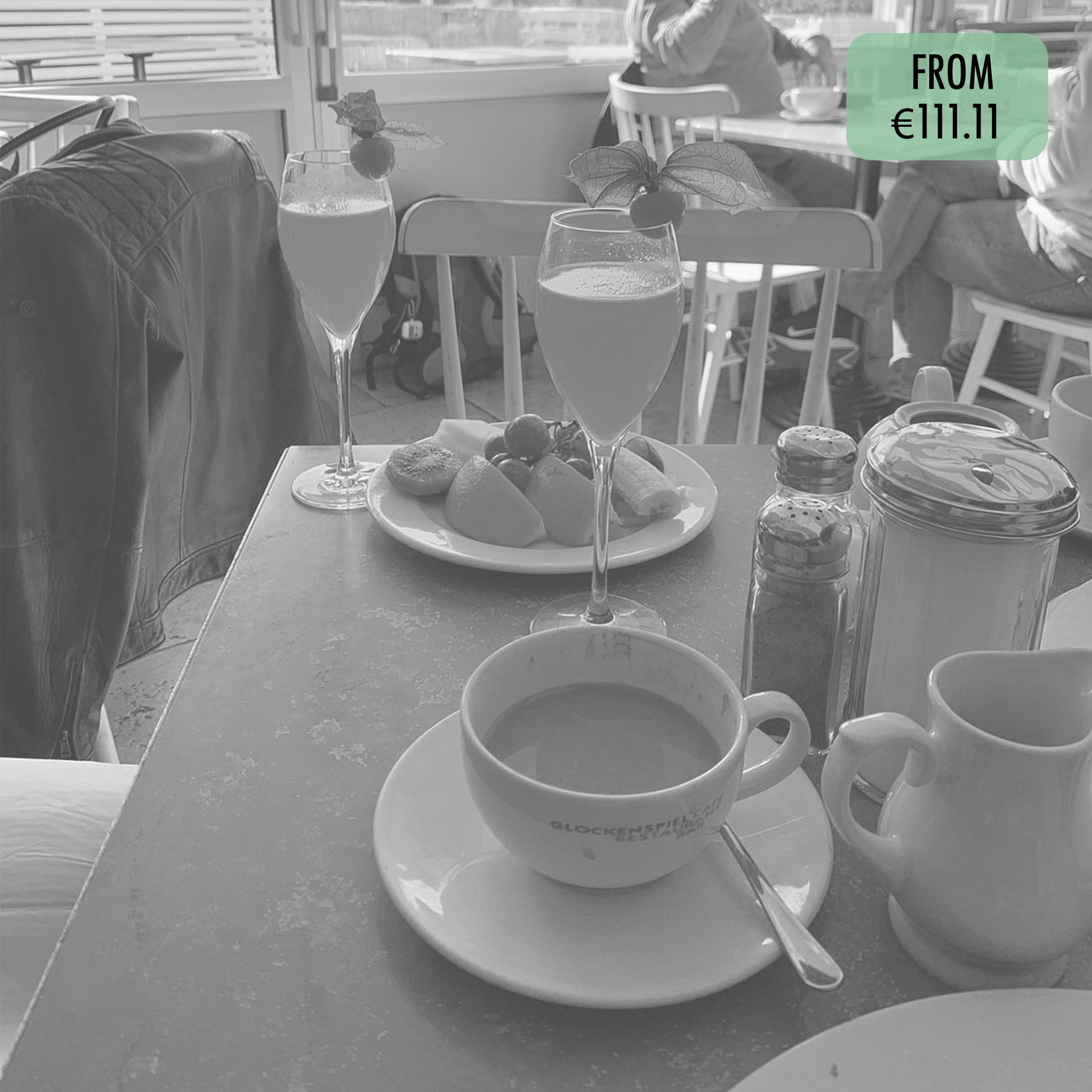 A black and white photo of a table with a cup of coffee on it