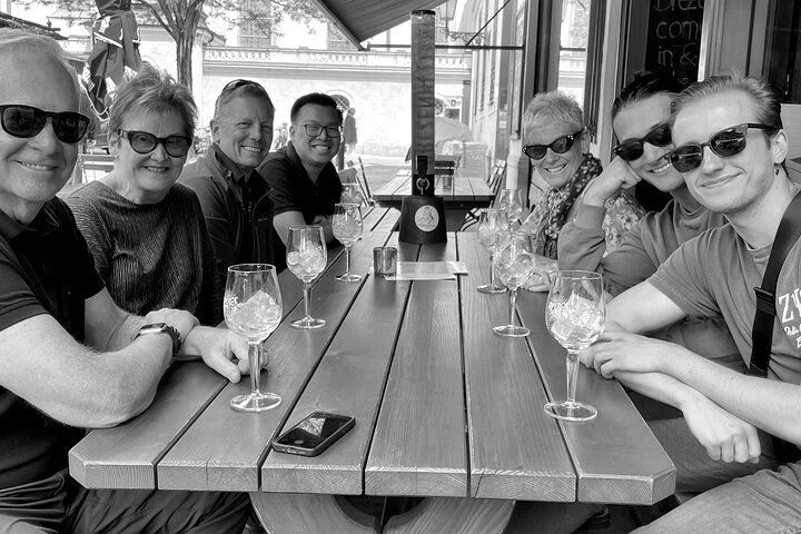 A group of people are sitting at a table with wine glasses.