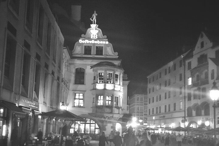 A black and white photo of a city street at night.