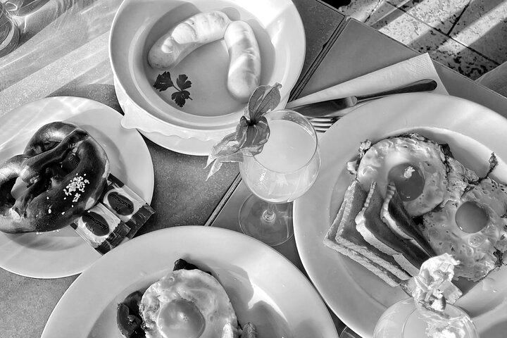 A black and white photo of plates of food on a table.