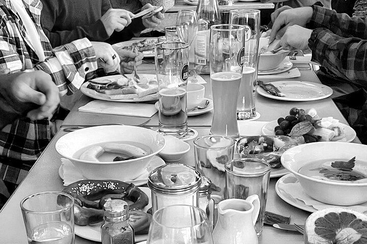A group of people are sitting at a table eating food.