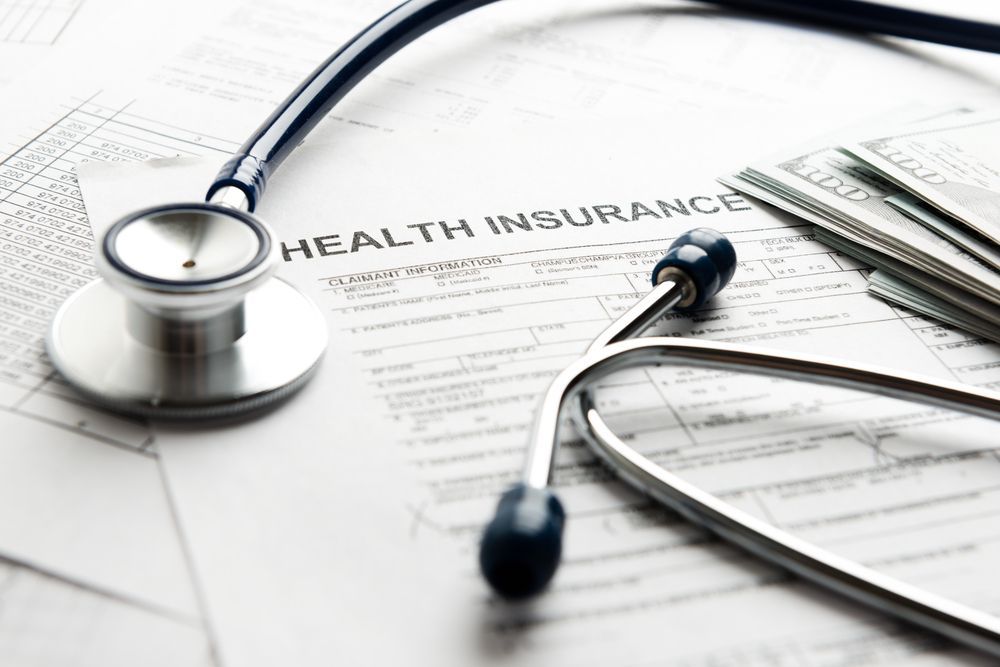Stethoscope on top of a health insurance form.