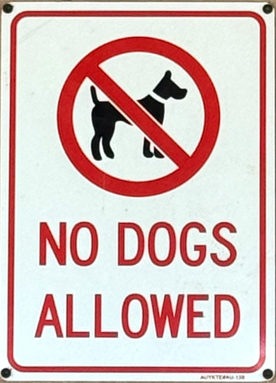 No dogs allowed sign with a red circle and slash over a black dog silhouette.