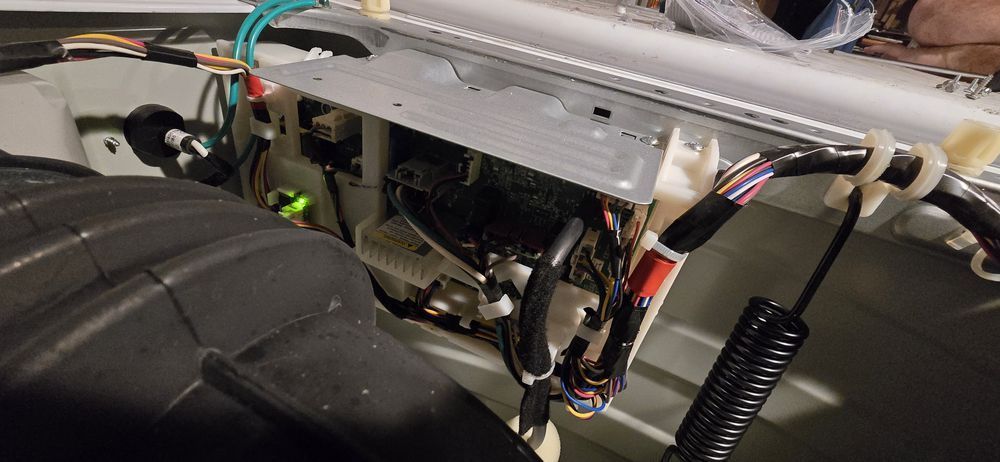 A close up of a car with a lot of wires coming out of it.