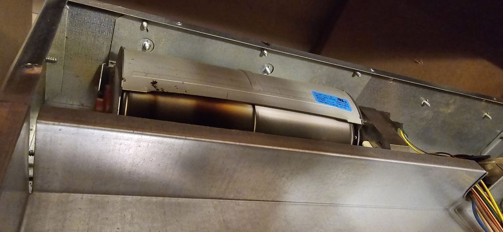 A close up of a metal item with a blue label on it