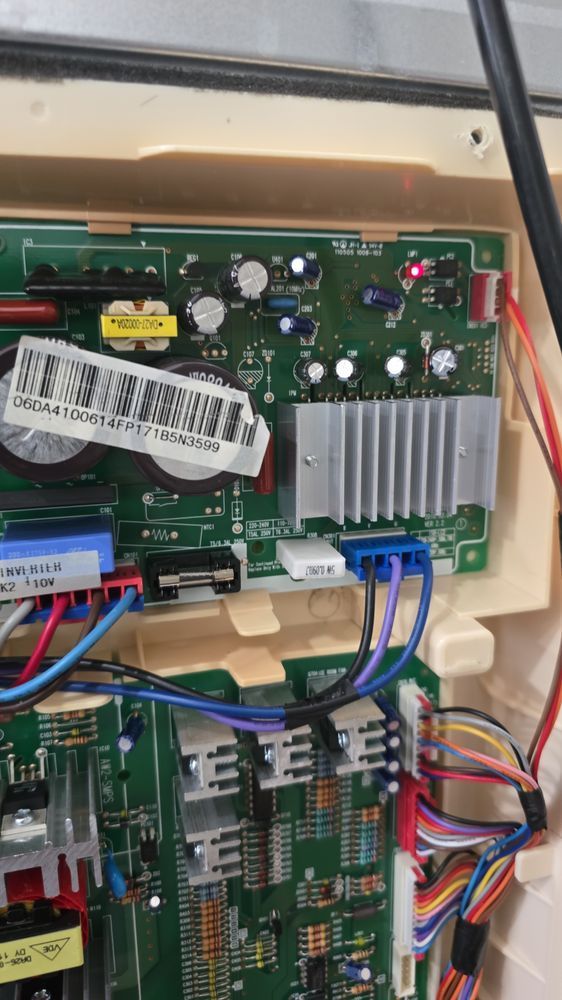 A close up of a motherboard with a lot of wires coming out of it.