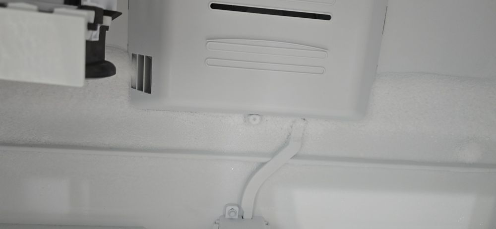 A black and white photo of the inside of a refrigerator.