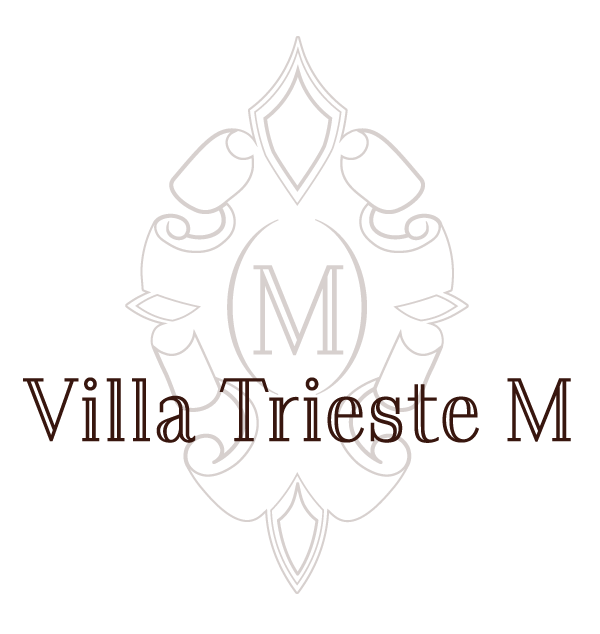 Villa Trieste M logo in brown text over a faint gray ornamental crest with a central M