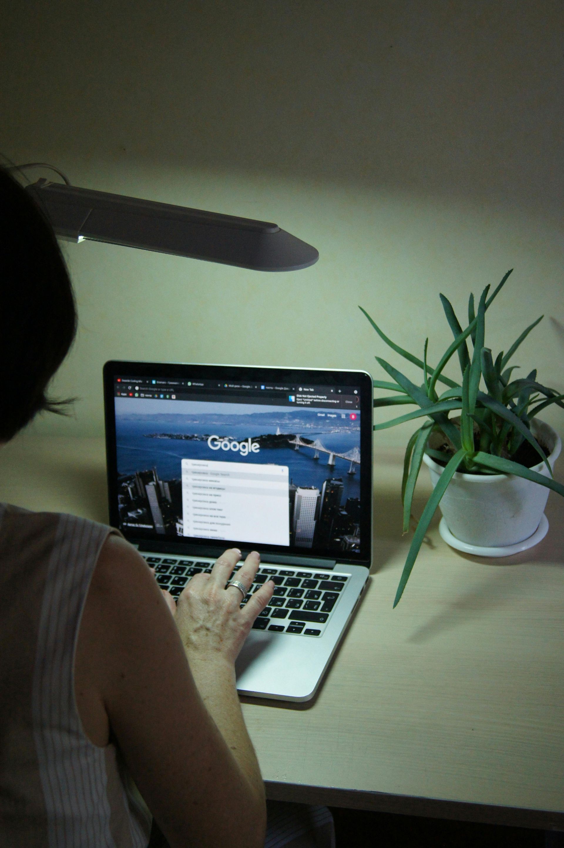 Person researching on a laptop showing Google search dropdown, highlighting user engagement with Google's updated search algorithms