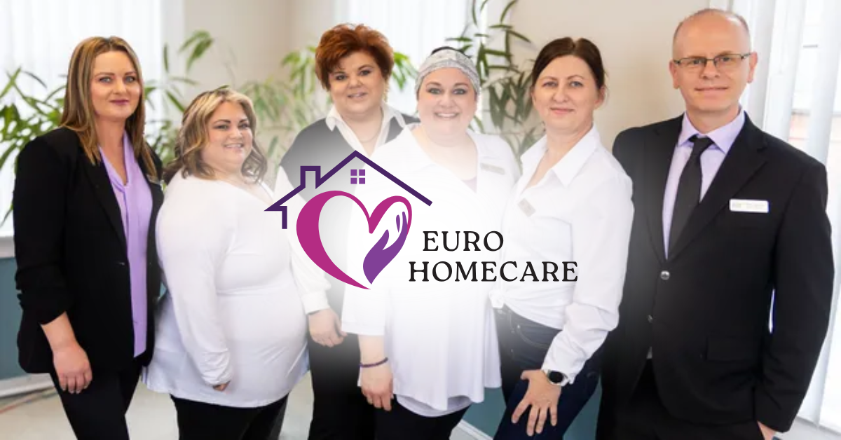 Five healthcare staff pose indoors around the Euro Homecare logo