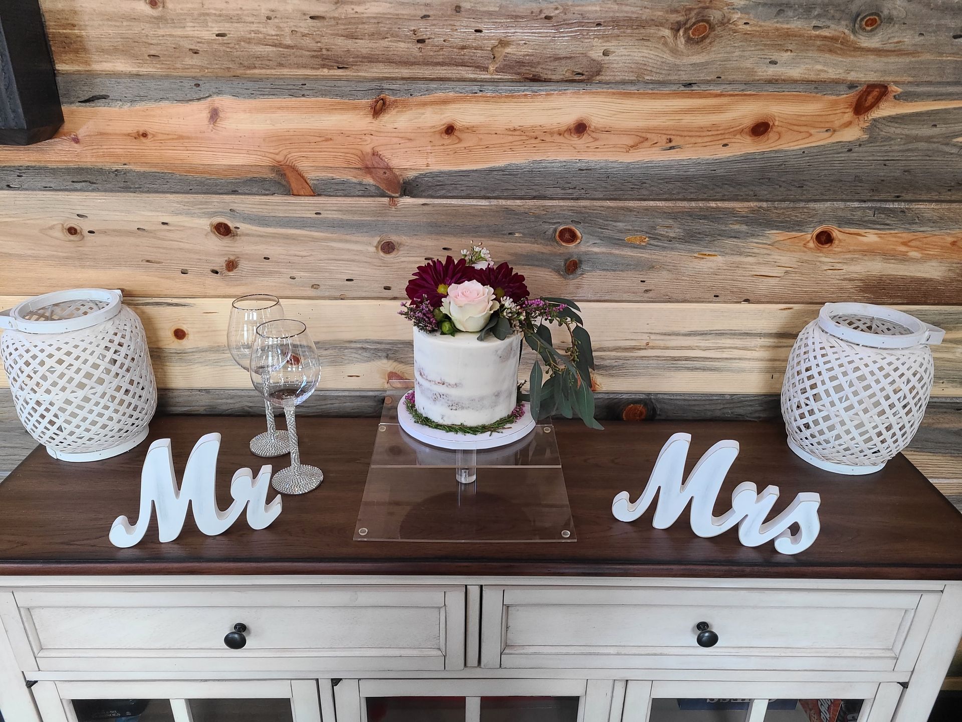 wedding reception mr. and mrs. signs next to wedding cake