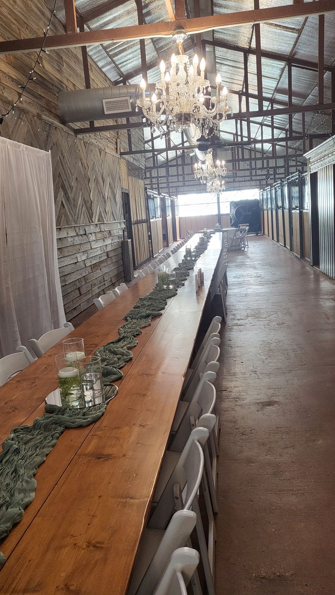 wedding reception in barn with long wooden table