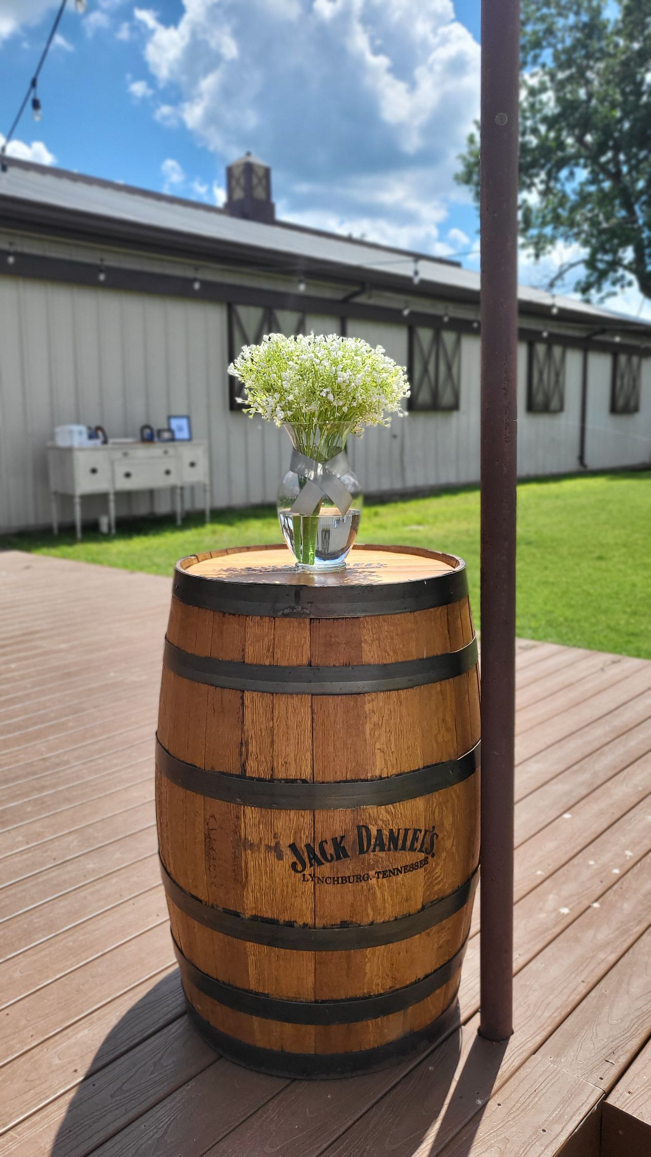 baby's breath flower arrangement on whiskey barrell