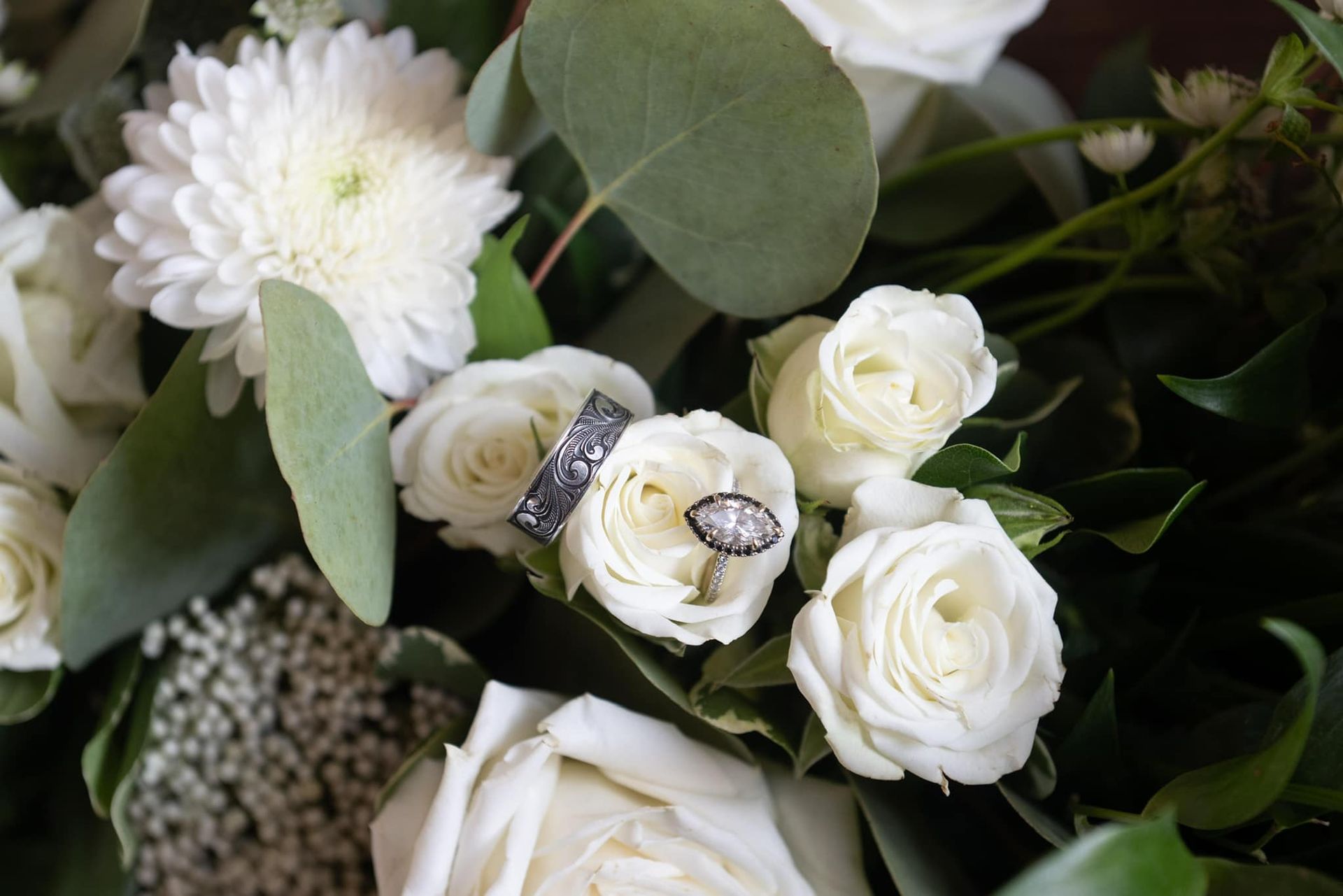 wedding rings in white rose bouquet