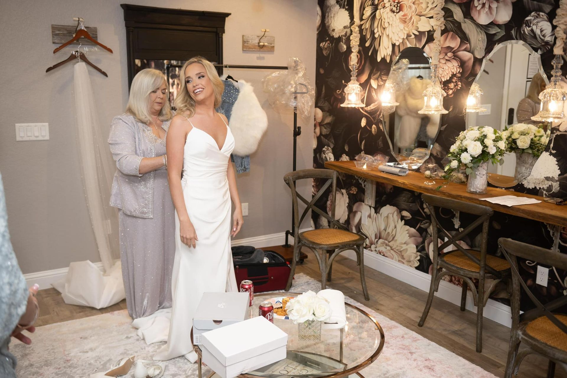 mother fastening bride's gown
