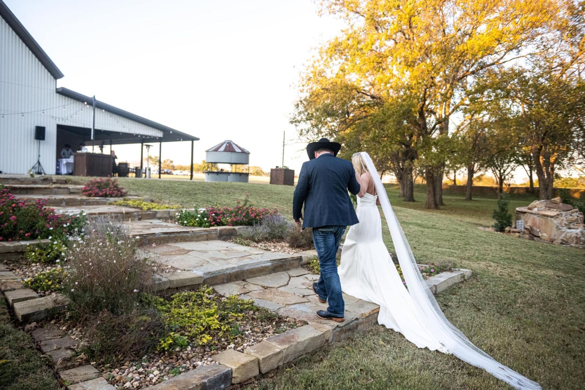 bride and groom walking down garden path