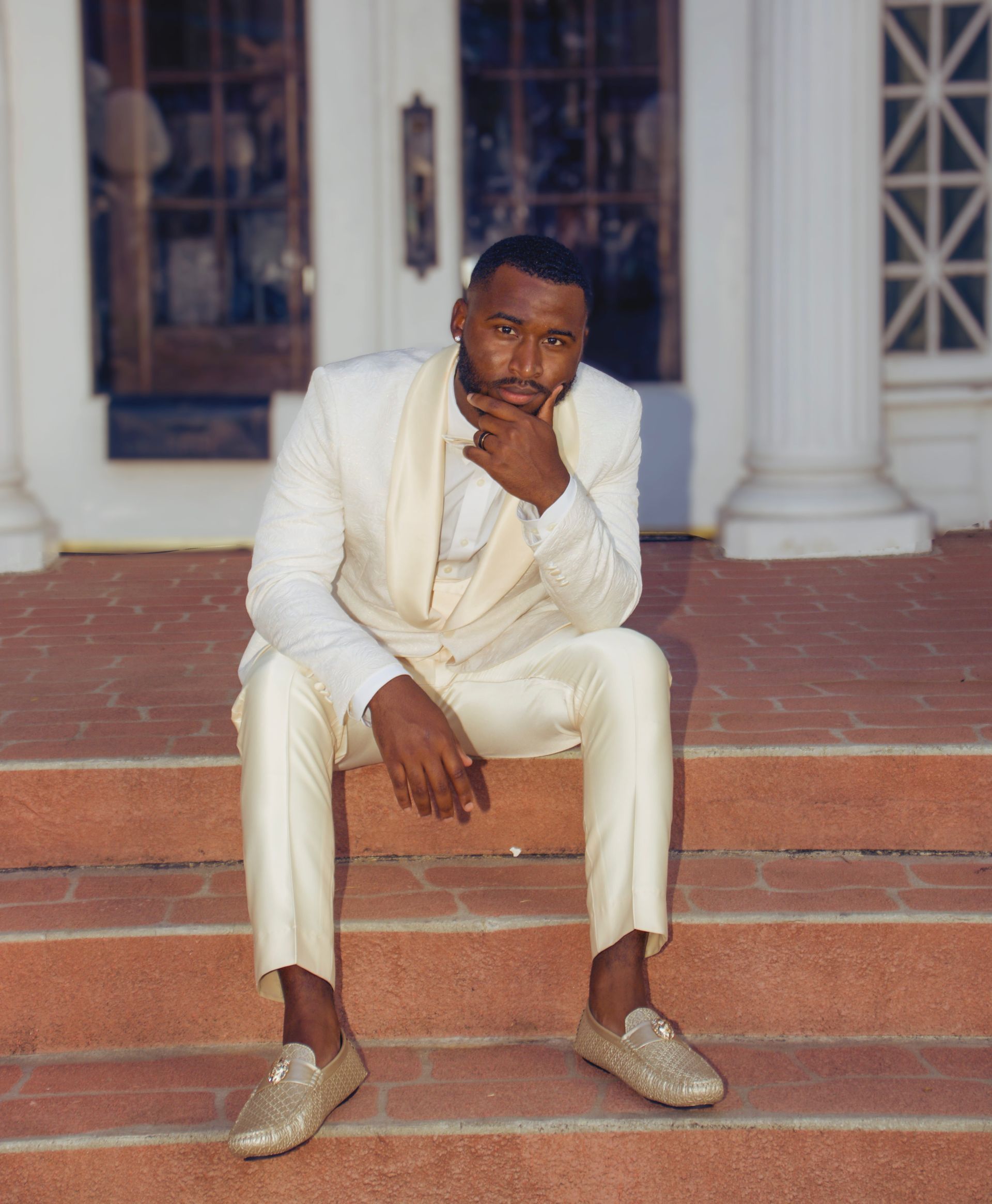 groom posing on venue steps