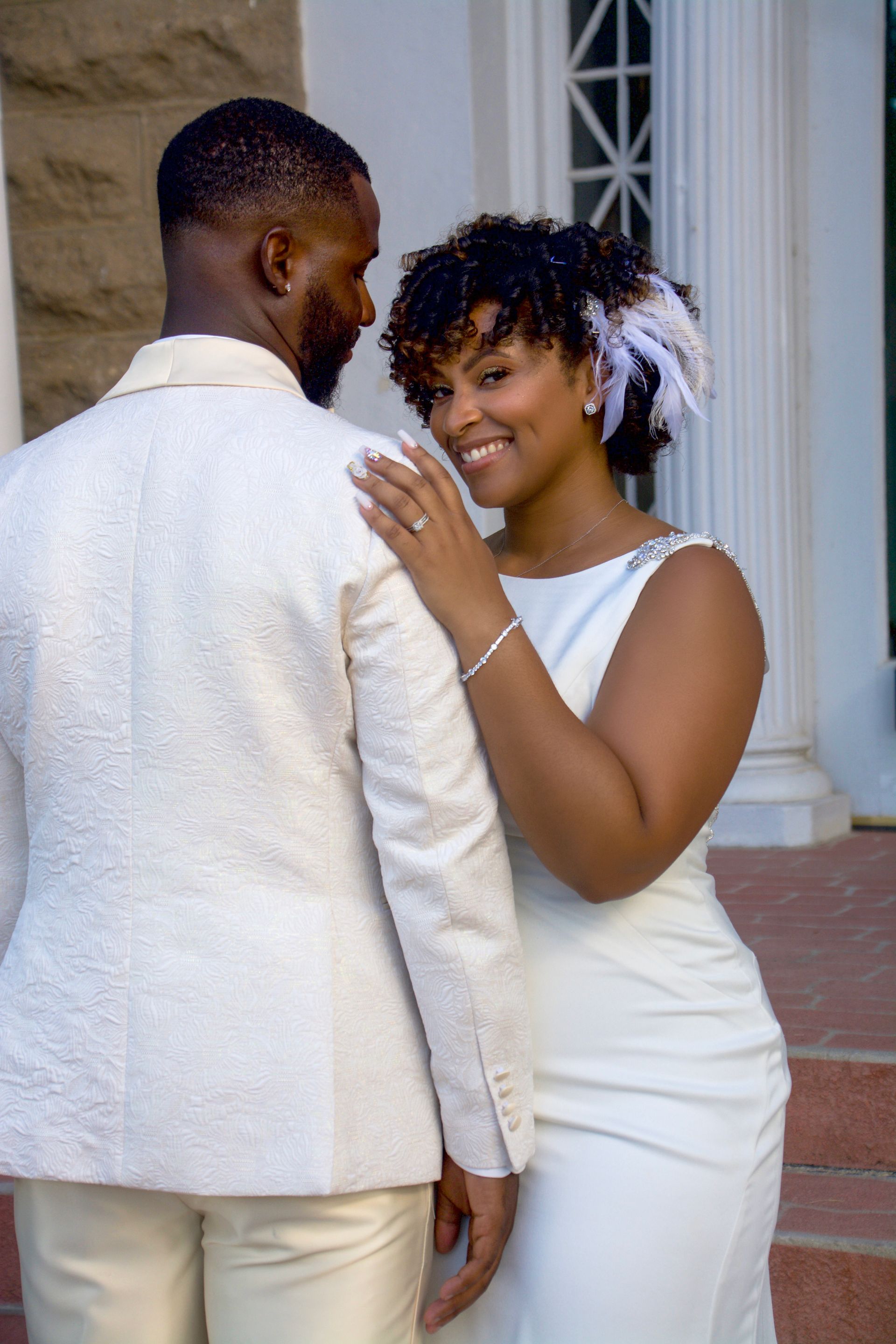 bride smiling while groom looks lovingly at her