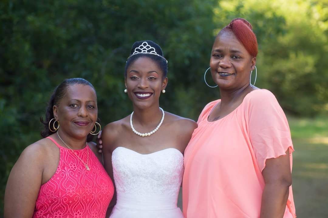 bride posing with family