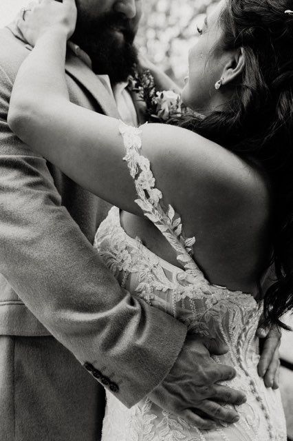 black and white photo of bride and groom embracing