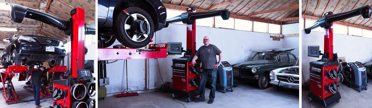 two cars are sitting on a lift in a garage .