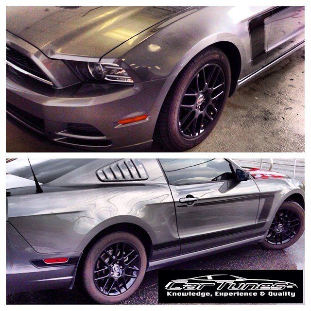 Gray Ford Mustang with black wheels, front and side views.