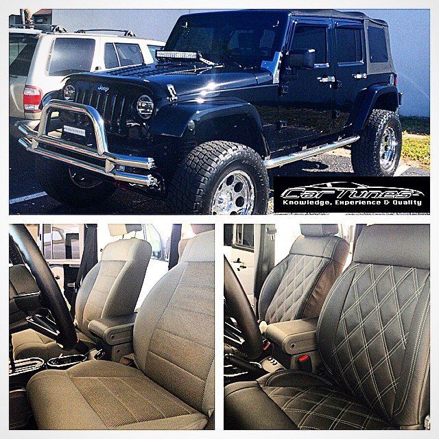 Black Jeep Wrangler with custom interior, parked outside.