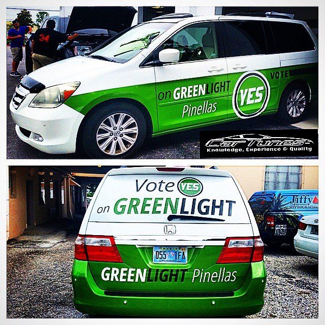 White and green Honda Odyssey van with 