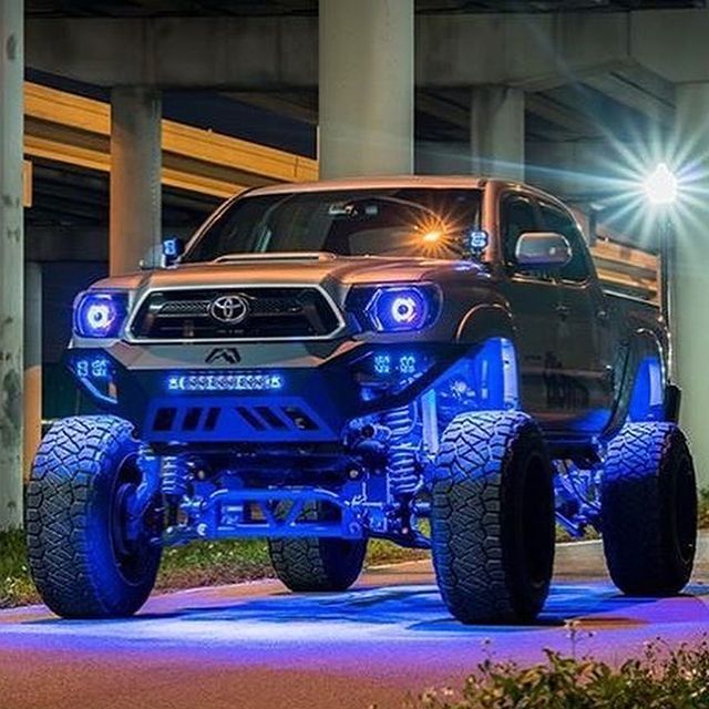 Modified Toyota Tacoma truck with blue LED lights.