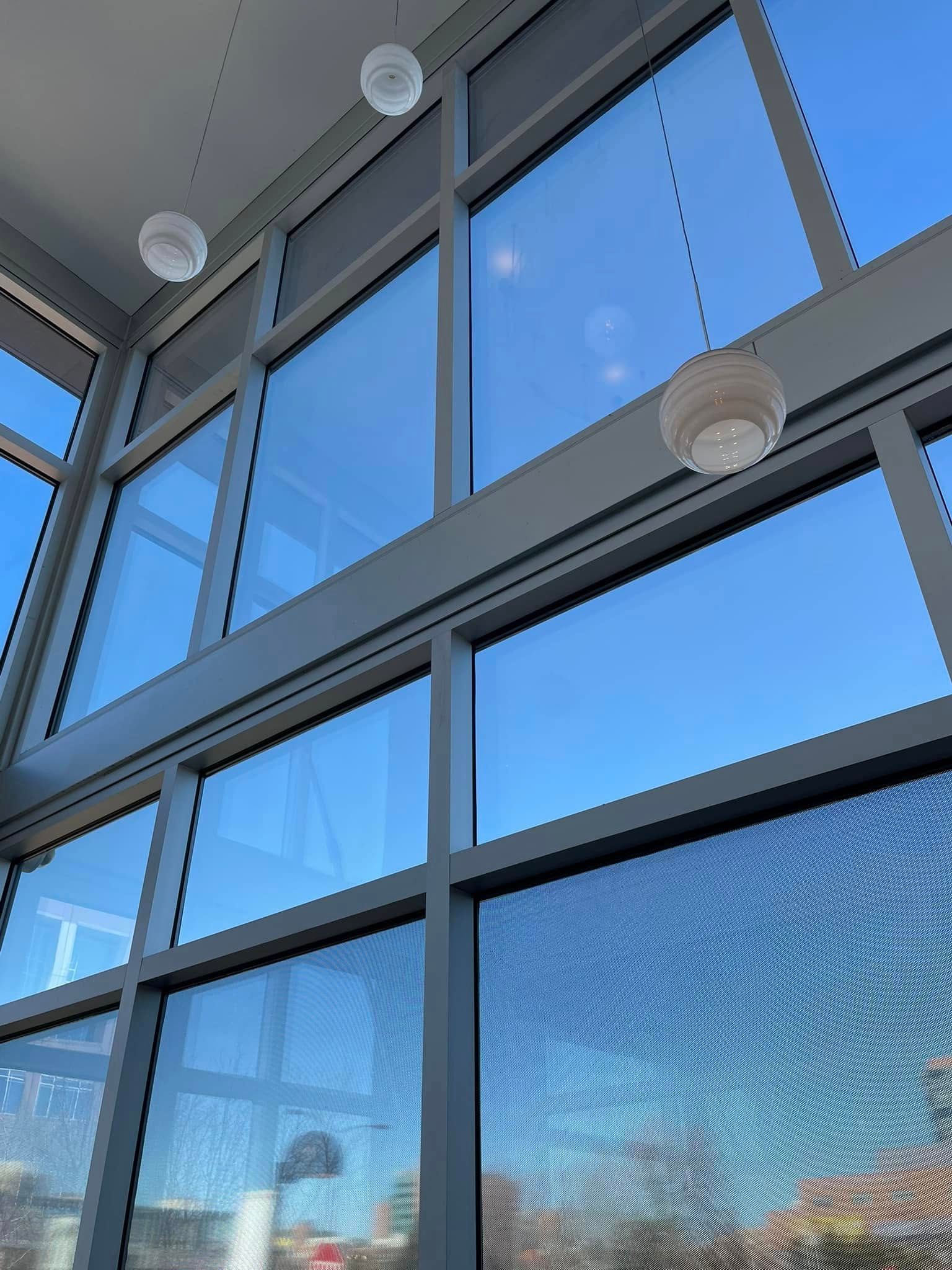 A building with a lot of windows and a blue sky behind them.