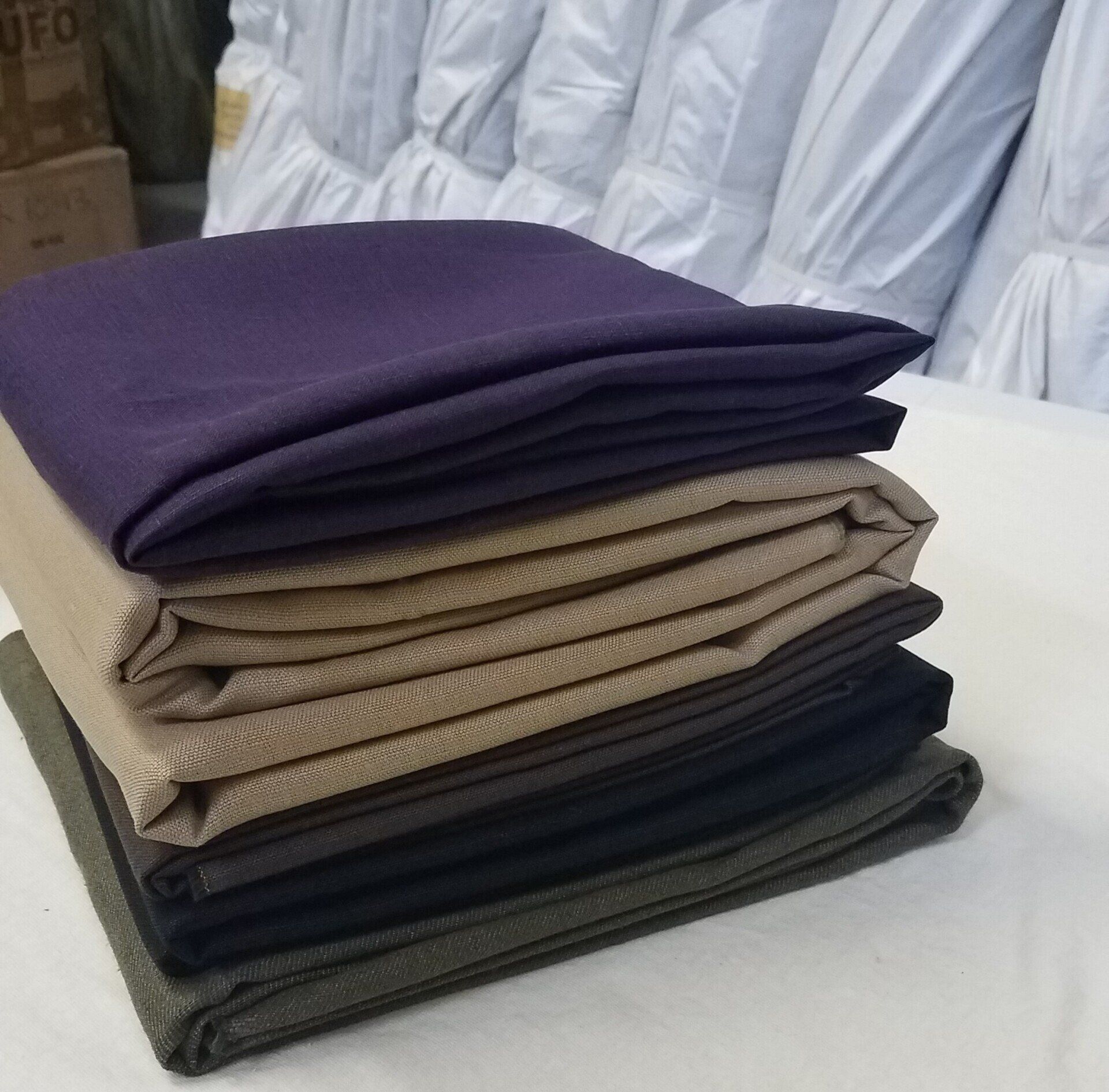 A stack of folded cloths with one being purple