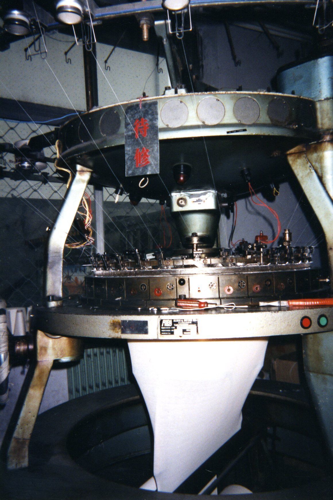 A machine is being used to make socks in a factory