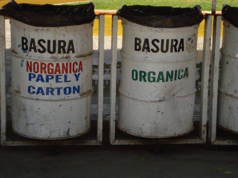 A row of trash cans with the word basura on them