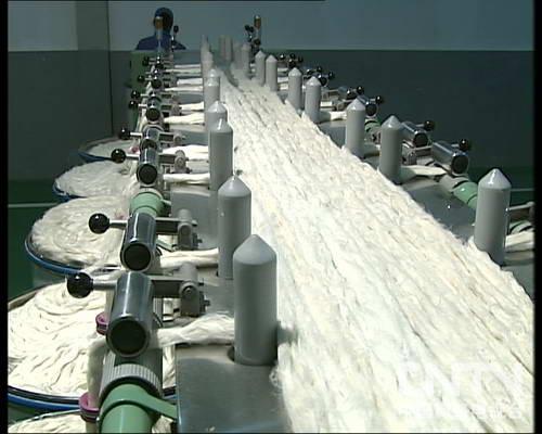 A conveyor belt with a lot of white cotton on it