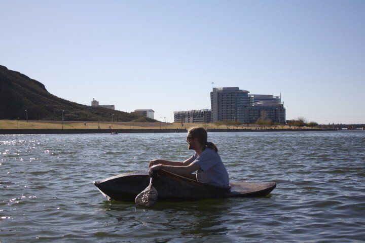 A person is sitting in a boat in the water