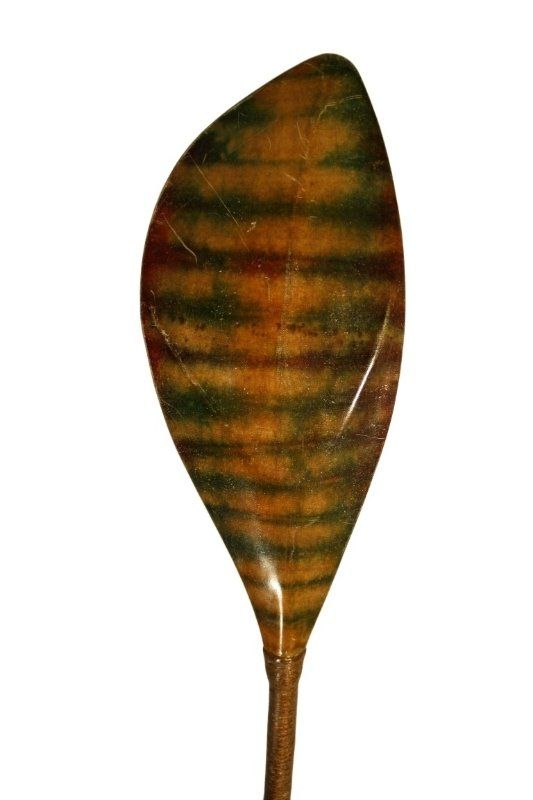 A close up of a leaf shaped object on a white background